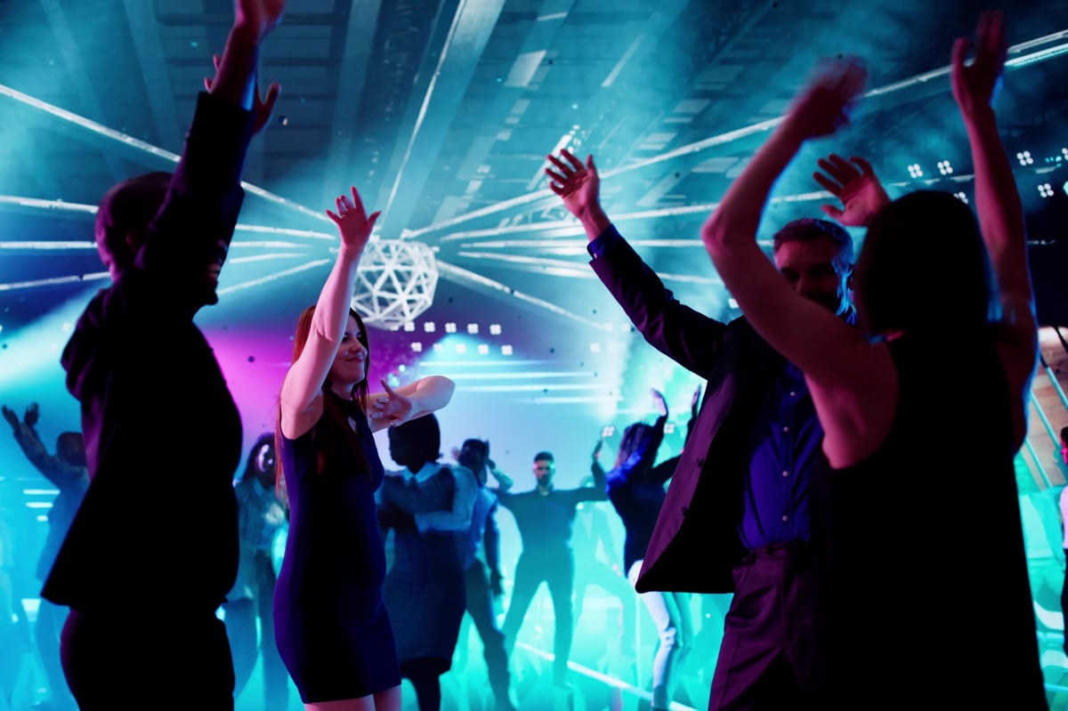 Diverse group of friends dancing at Taboo nightclub